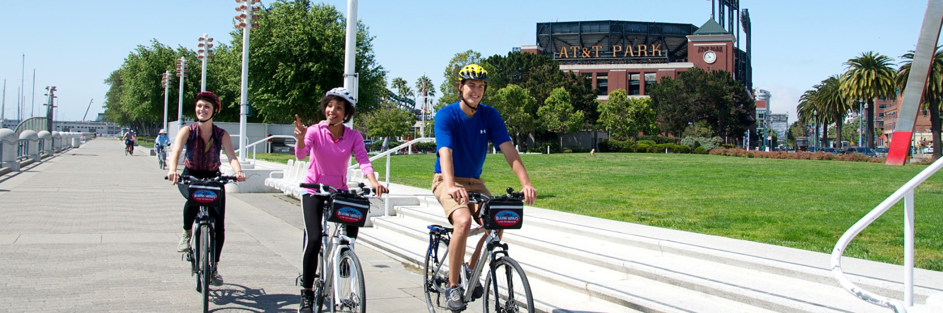 Three bikers enjoing a beautiful day riding around AT&amp;T Park in San Francisco