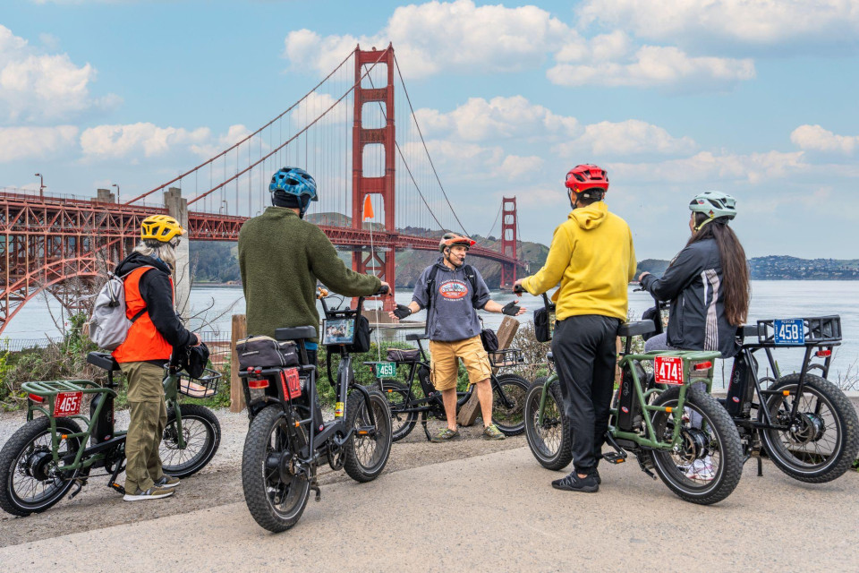 Family riders taking in the Golden Gate Bridge shoreline view