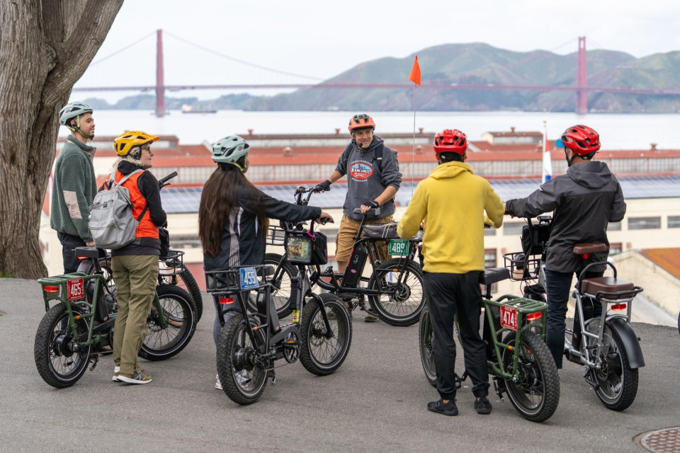 Family group gathered with electric bikes along the bay