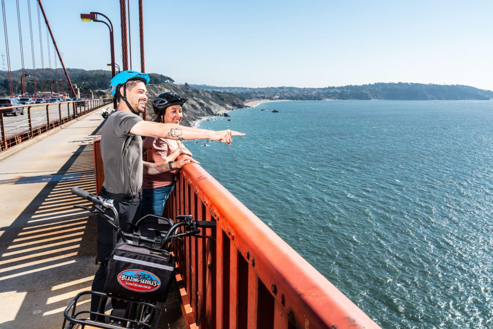 Rider overlooking open water from the bridge route
