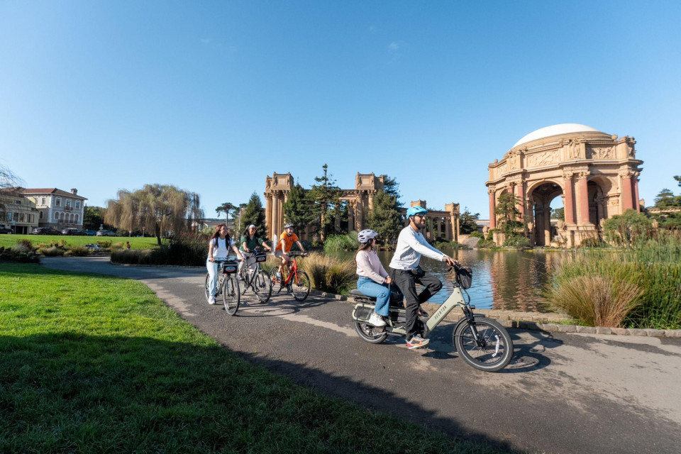 Family group riding near the Palace of Fine Arts lagoon