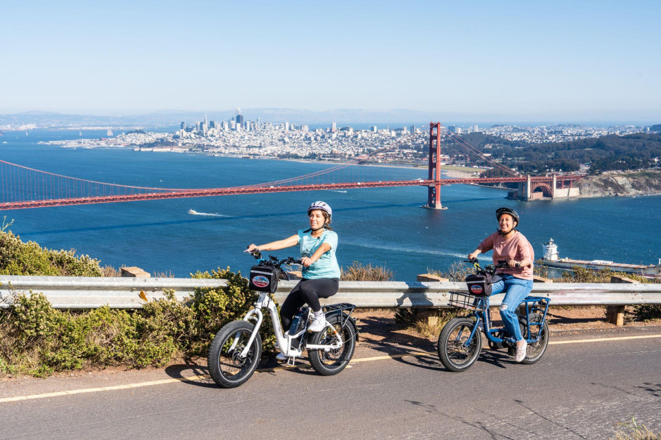 Electric bike at a scenic overlook with bay and city in view