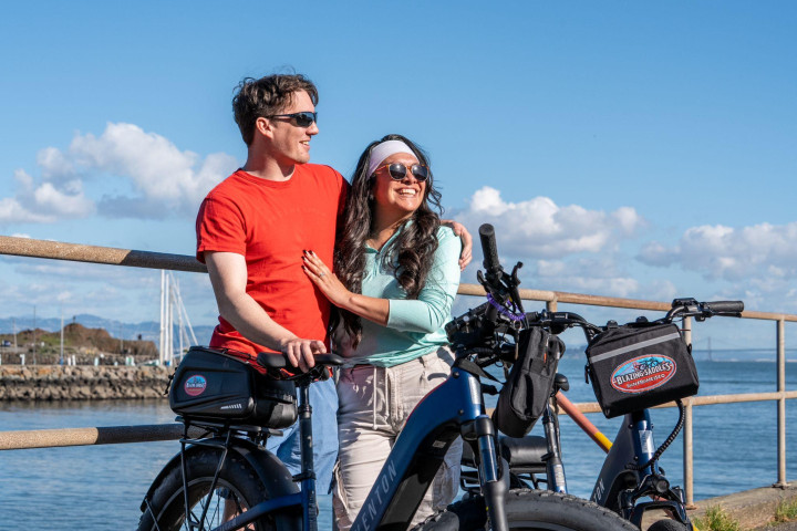 Riders cruising on electric bikes along the waterfront