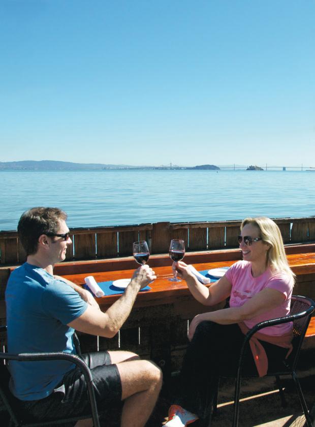 Couple enjoing wine and stunning views in Sausalito after biking the Golden Gate Bridge