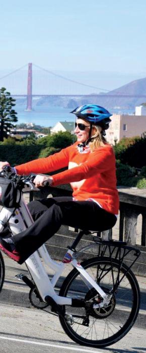 Woman riding up the hilly streets of San Francisco with ease on an Electric Bike