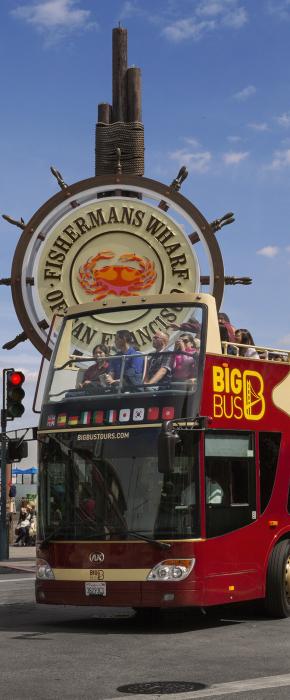Big Bus open-top tour cruising along iconic Fisherman's Wharf in San Francisco